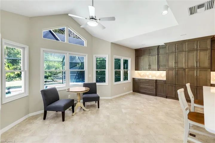 Bright breakfast nook with vaulted ceilings and abundant natural light.
