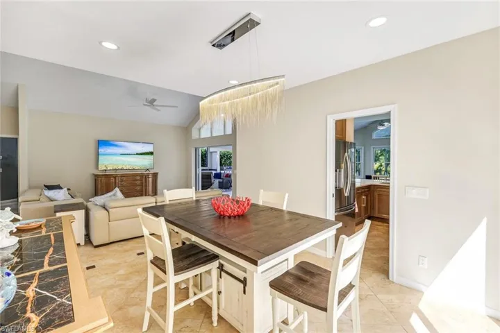 Bright open dining area highlighted by designer lighting and seamless flow to the kitchen and living spaces.