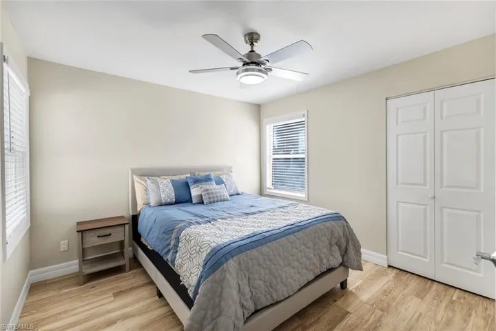 Comfortable third bedroom featuring tile flooring and abundant natural light