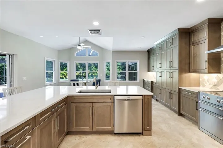 Spacious kitchen with quartz surfaces and peninsula seating ideal for casual dining and entertaining.
