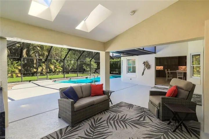 Covered lanai lounge offering comfortable outdoor seating and poolside entertaining space.