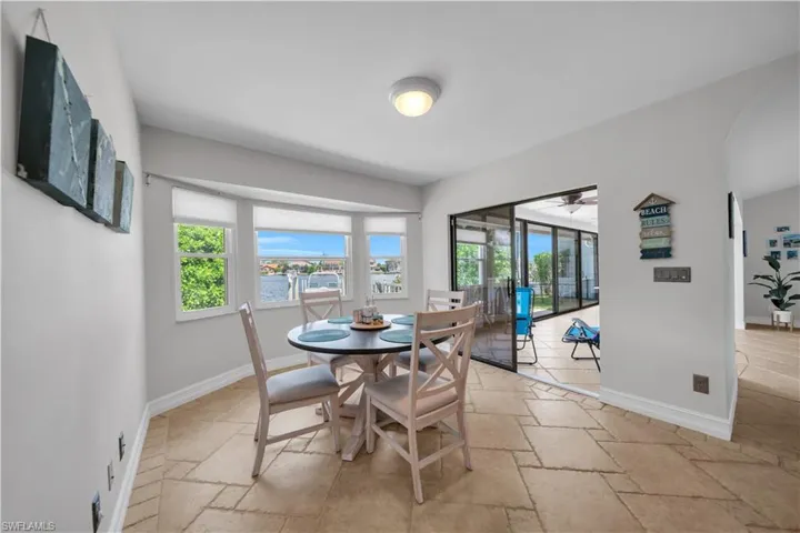 Dining area with stone tile flooring and arched walkways