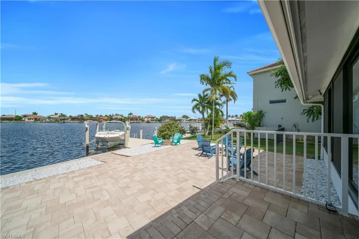 View of patio / terrace with a dock, a water view, and boat lift