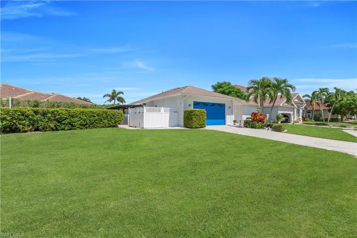 Single story home with concrete driveway, a gate, and a garage