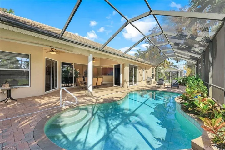 Incredible pool area with covered lanai, sunning area and beautiful landscaping