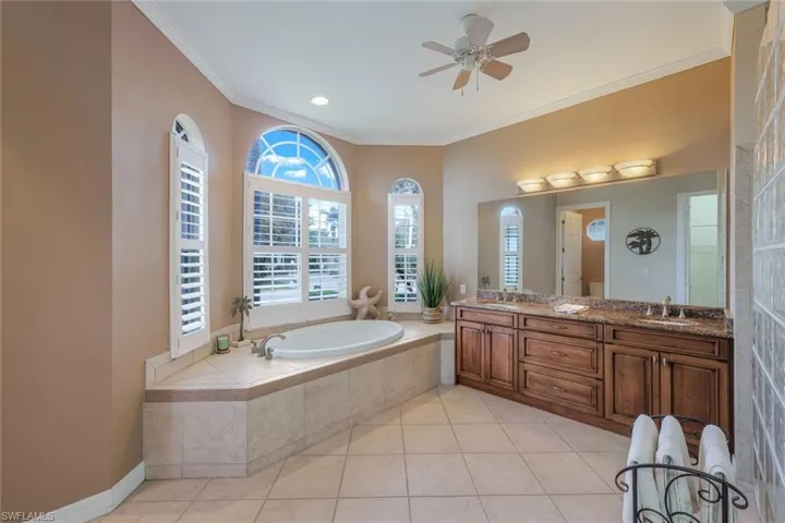 Elegant, spacious primary bathroom with soaking tub, walk-in shower, dual sinks and private water closet