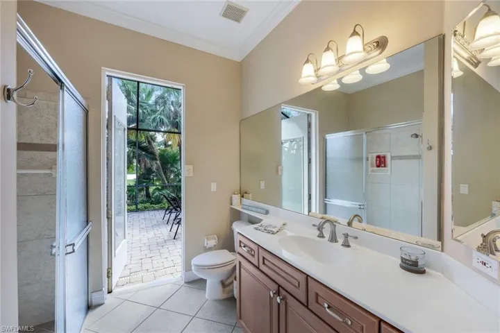 Guest bathroom with walk-in shower and access to the pool area