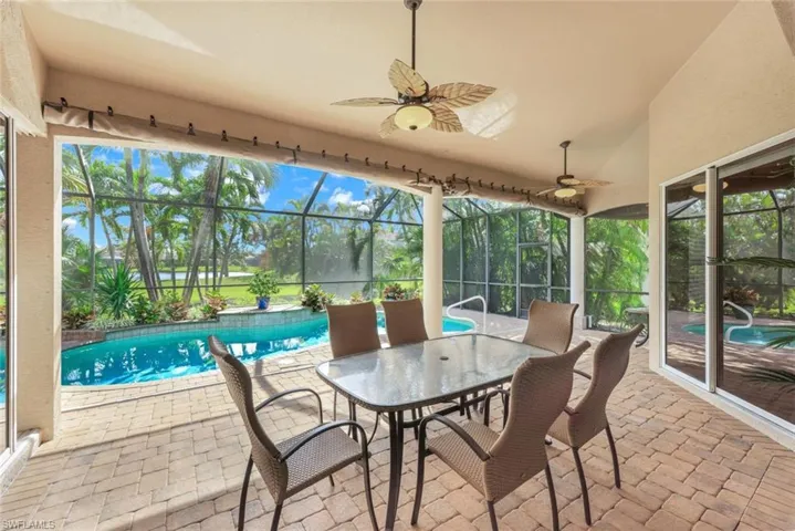 Spacious lanai with nice lighting/decorative fans, paver flooring and access to great room, kitchen and primary bedroom and storm protection