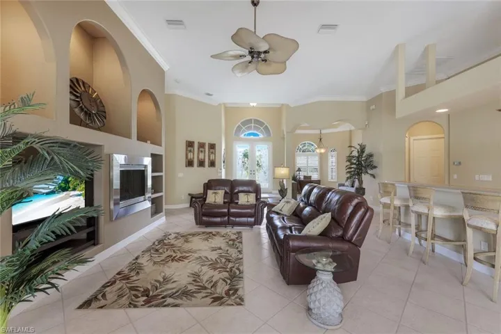 Spacious great room with soaring ceilings & nice built-ins. Bright elegant entry.