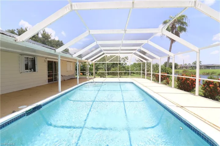 View of pool with a patio and a lanai