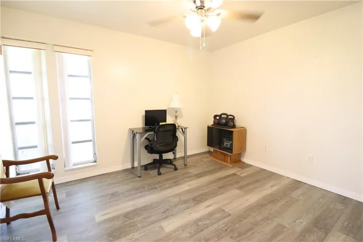 Home office featuring ceiling fan and hardwood / wood-style floors