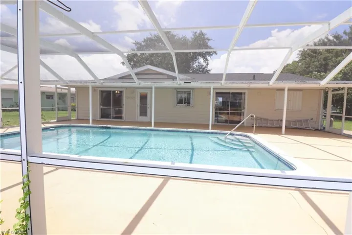 View of pool with a patio area and a lanai
