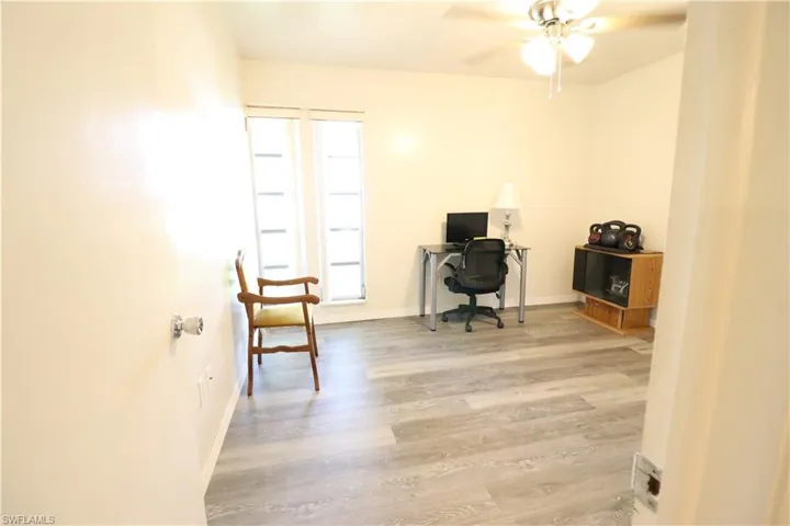 Office area with ceiling fan and hardwood / wood-style flooring