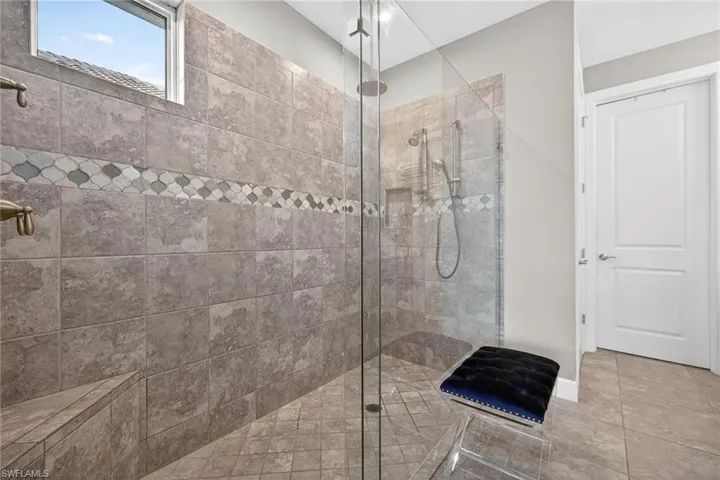 Full bathroom with a walk in shower and tile patterned flooring