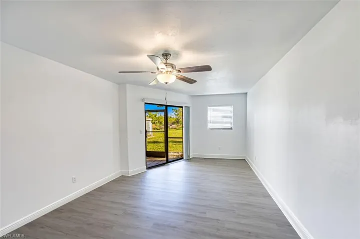 Empty room with light wood-type flooring and ceiling fan