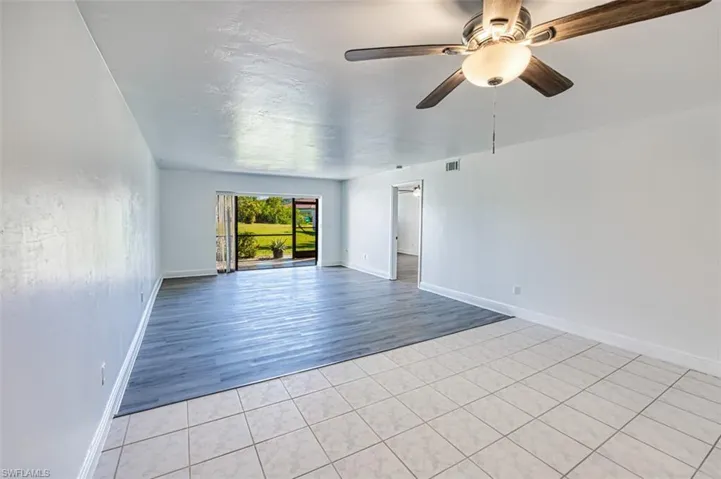 Spare room with light tile patterned flooring and ceiling fan