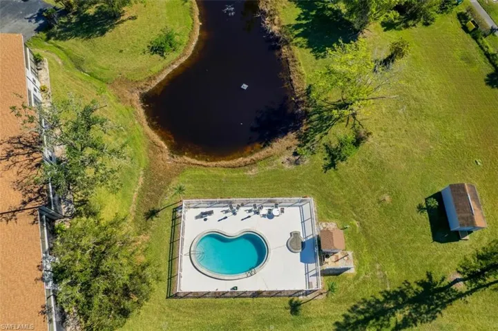 Bird's eye view of a pool area and a large body of water