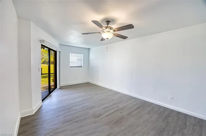Spare room with wood finished floors and a ceiling fan