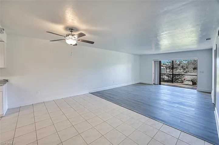 Unfurnished room featuring light tile patterned flooring and a ceiling fan