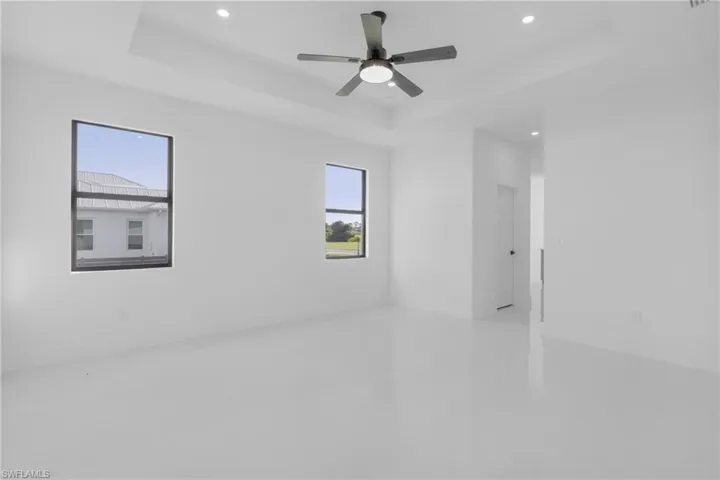 Spare room with ceiling fan and a raised ceiling