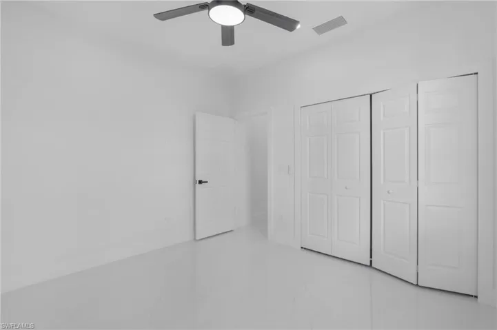 Unfurnished bedroom with a closet and ceiling fan