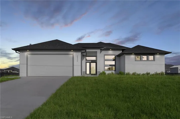 Prairie-style home featuring a garage and a yard