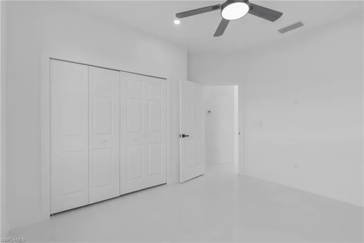 Unfurnished bedroom featuring a closet, tile patterned flooring, and ceiling fan