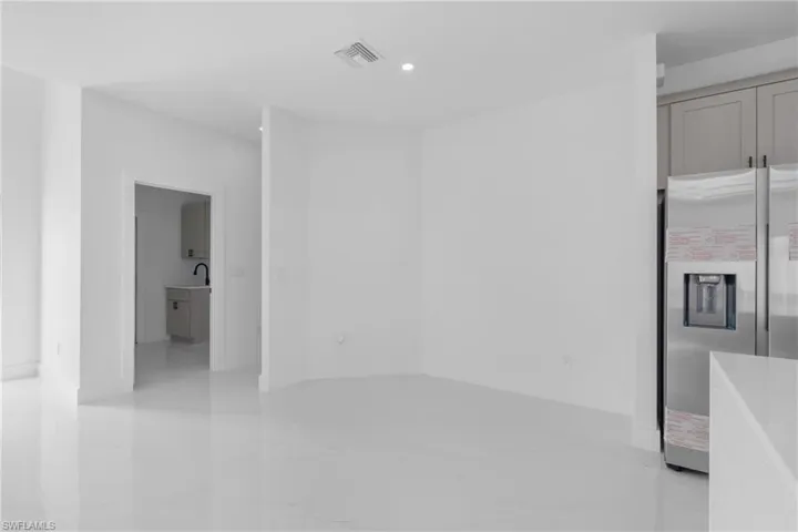 Spare room featuring sink and light tile patterned floors