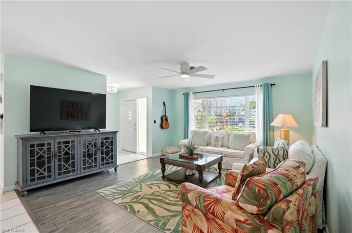 Living area featuring ceiling fan and wood finished floors