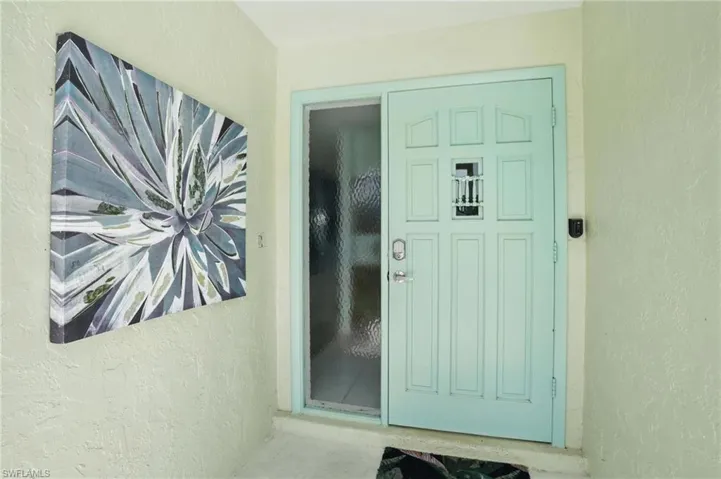 Entrance to property with stucco siding