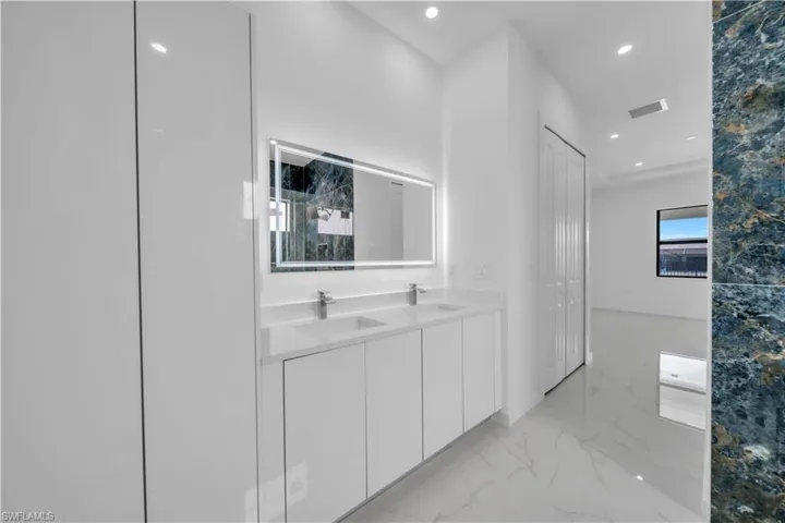 Hall featuring recessed lighting and light marble finish flooring