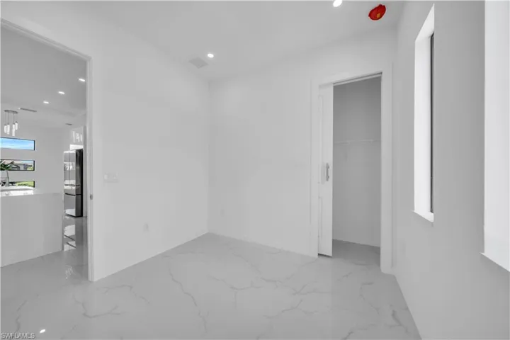 Spare room with recessed lighting and light marble finish flooring