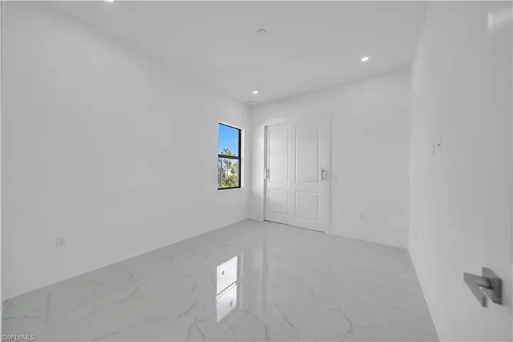 Unfurnished bedroom with recessed lighting and light marble finish floors