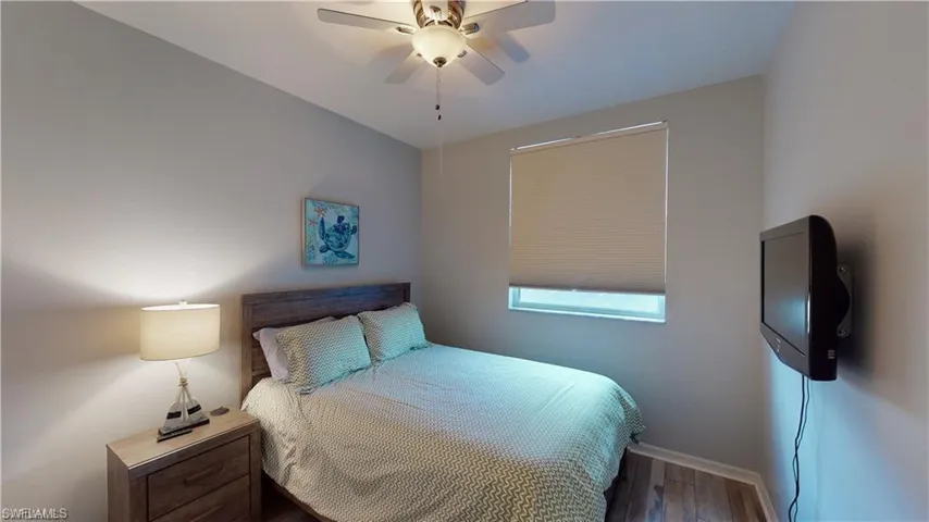Bedroom featuring wood finished floors and a ceiling fan
