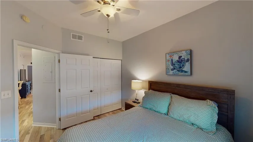 Bedroom featuring wood finished floors, a closet, and ceiling fan