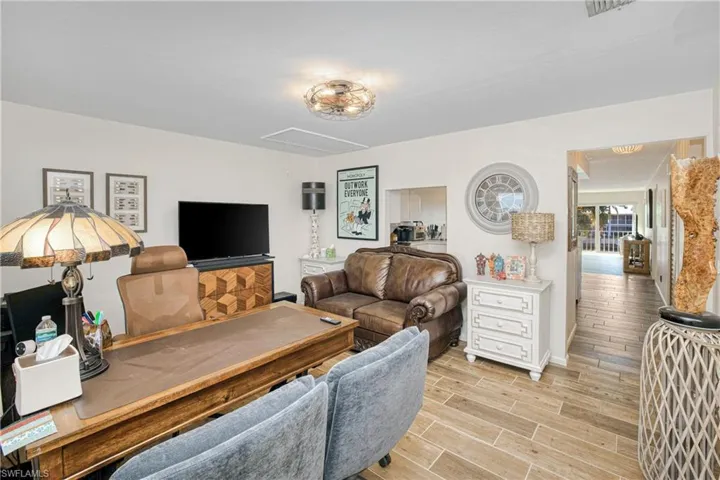Living area with attic access and wood tiled floors