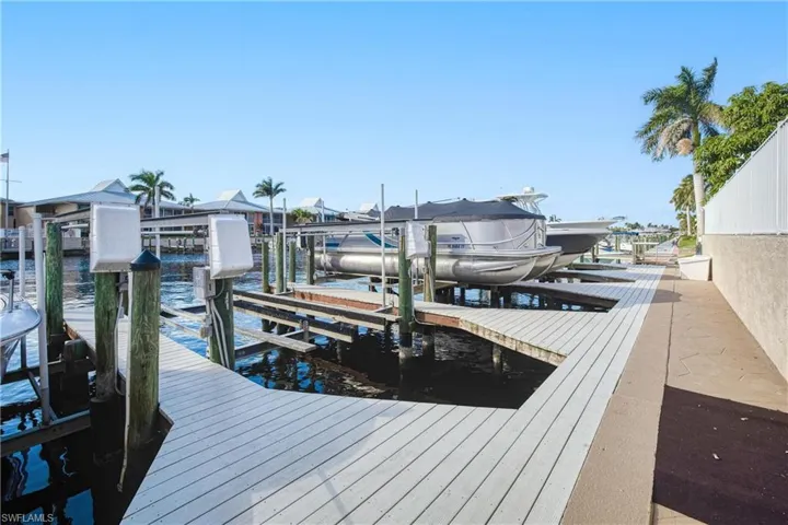 Dock featuring boat lift and a water view