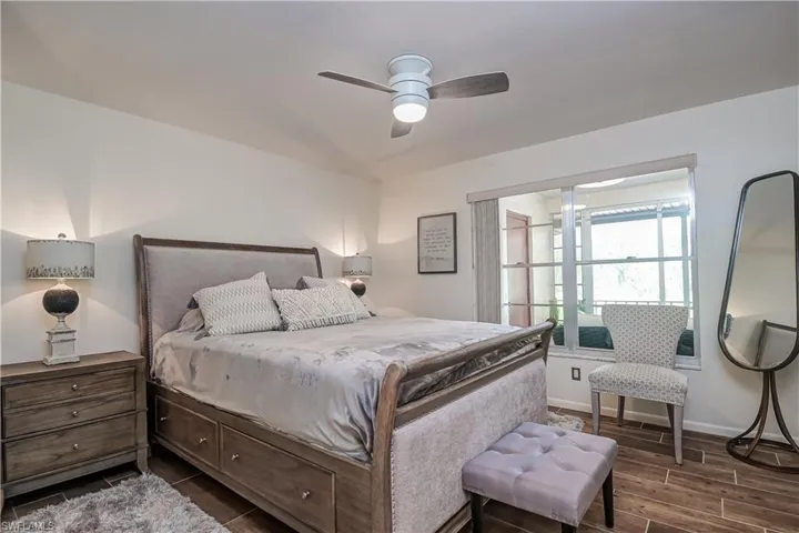 Bedroom 2 with a ceiling fan and wood tiled floors