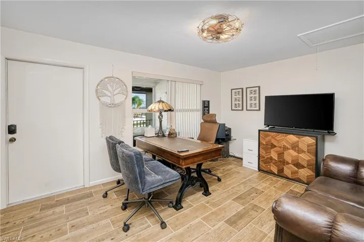 Home office featuring attic access and wood finish floors