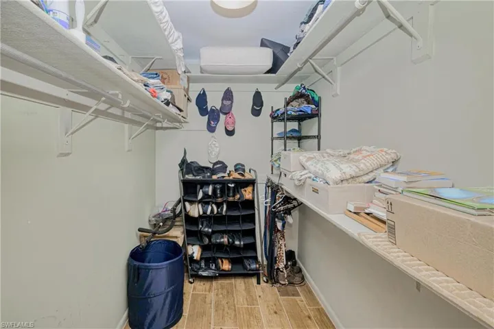 Walk in closet with wood tiled floors