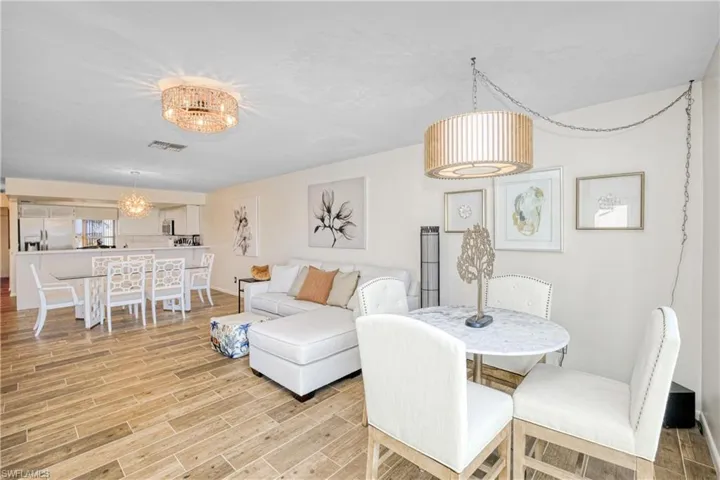 Dining space with wood finish floors and a chandelier
