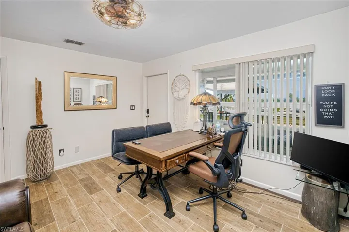 Home office with wood tiled floors and baseboards