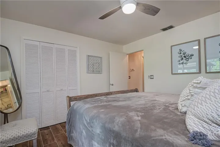 Bedroom 2 with wood finish floors, a closet, and ceiling fan