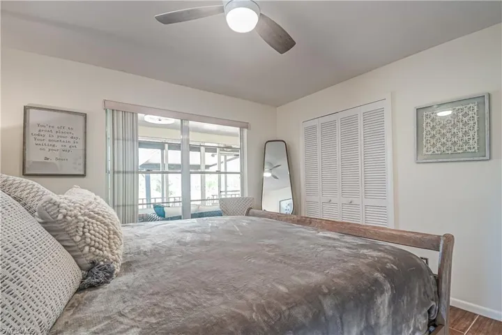Bedroom 2 featuring a closet, ceiling fan, and wood finished floors