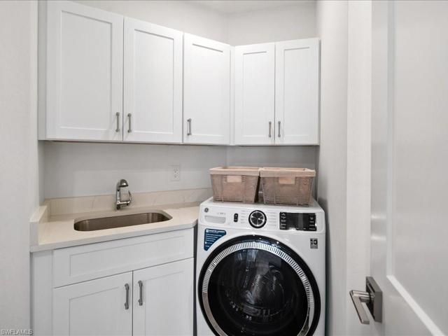 Laundry with sink, storage and new washer and dryer