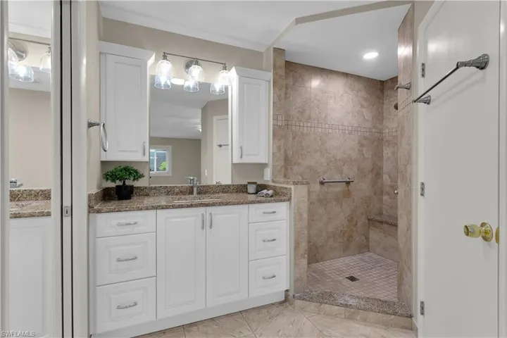Step inside to a BEAUTIFULLY REMODELEDINTERIOR featuring REMODELED BATHROOMSw/ GRANITE COUNTERTOPS, WHITE CABINETS,TILED STAND-UP SHOWER WITH ADACOMPLIANCE