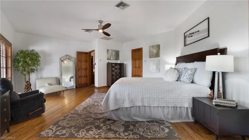 Bedroom with wood finished floors and a ceiling fan