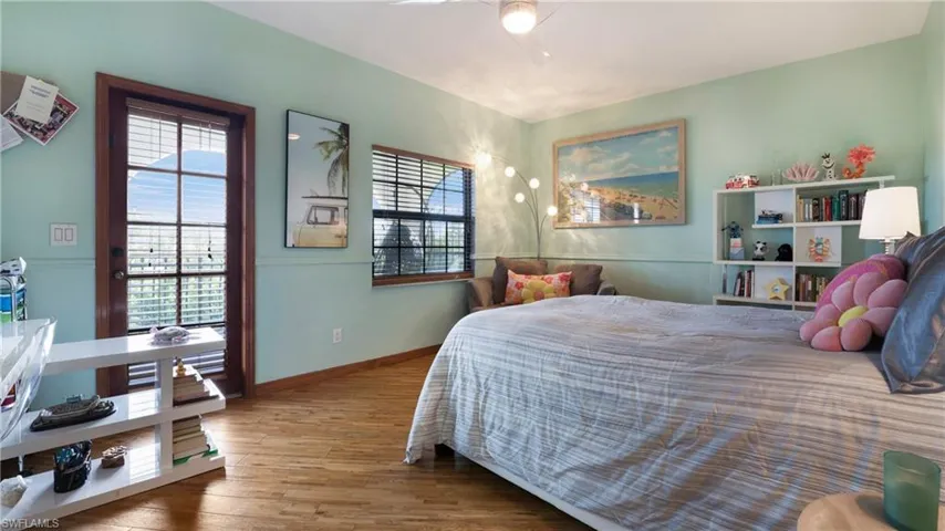 Bedroom with wood finished floors and a ceiling fan