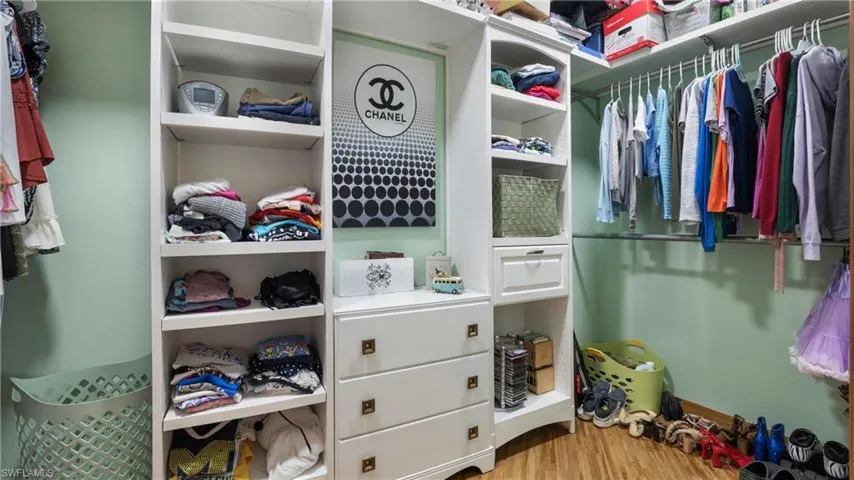 Walk in closet featuring light wood-style floors