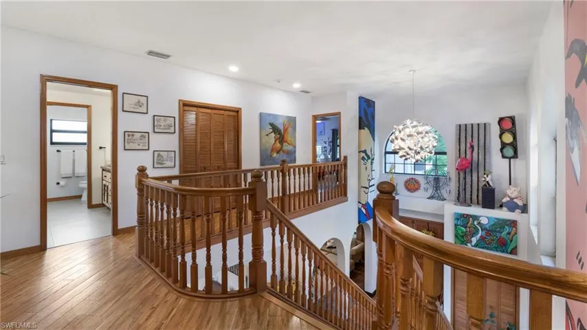 Corridor featuring an upstairs landing, a chandelier, wood finished floors, and recessed lighting